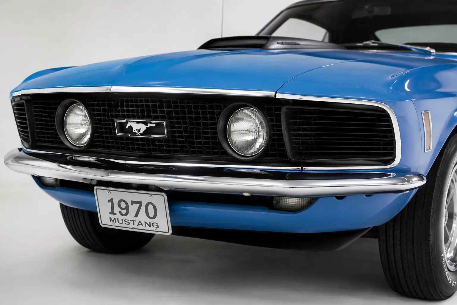 Close-up of the 1970 Ford Mustang front grille showing two large inboard headlights and simulated air intake covers in the outboard positions